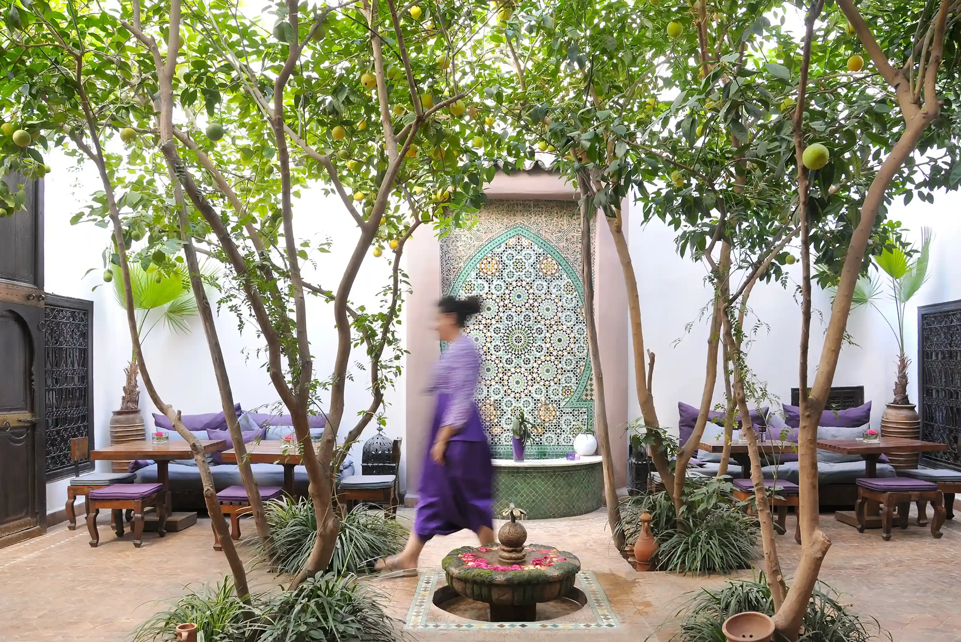The patio of Riad Houdou, with a fountain and orange trees.
